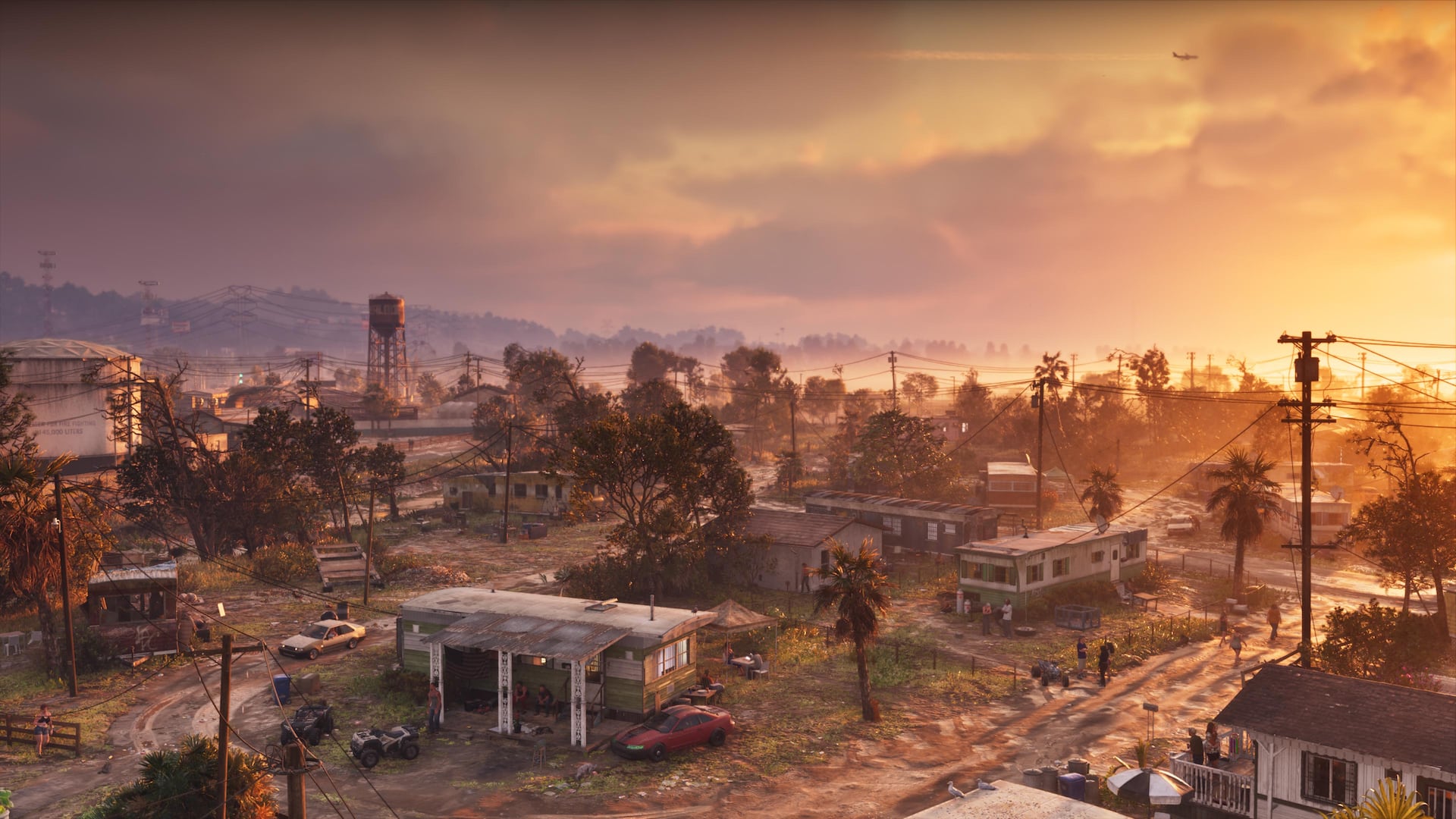 A Port Gellhorn neighborhood and palm-lined street at sunset in Grand Theft Auto VI